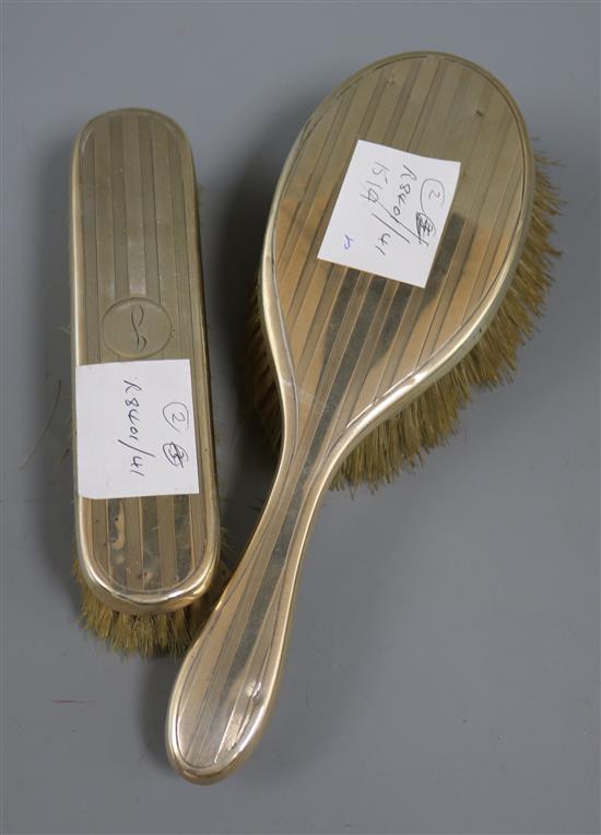 Two George V silver engine turned dressing table brushes.